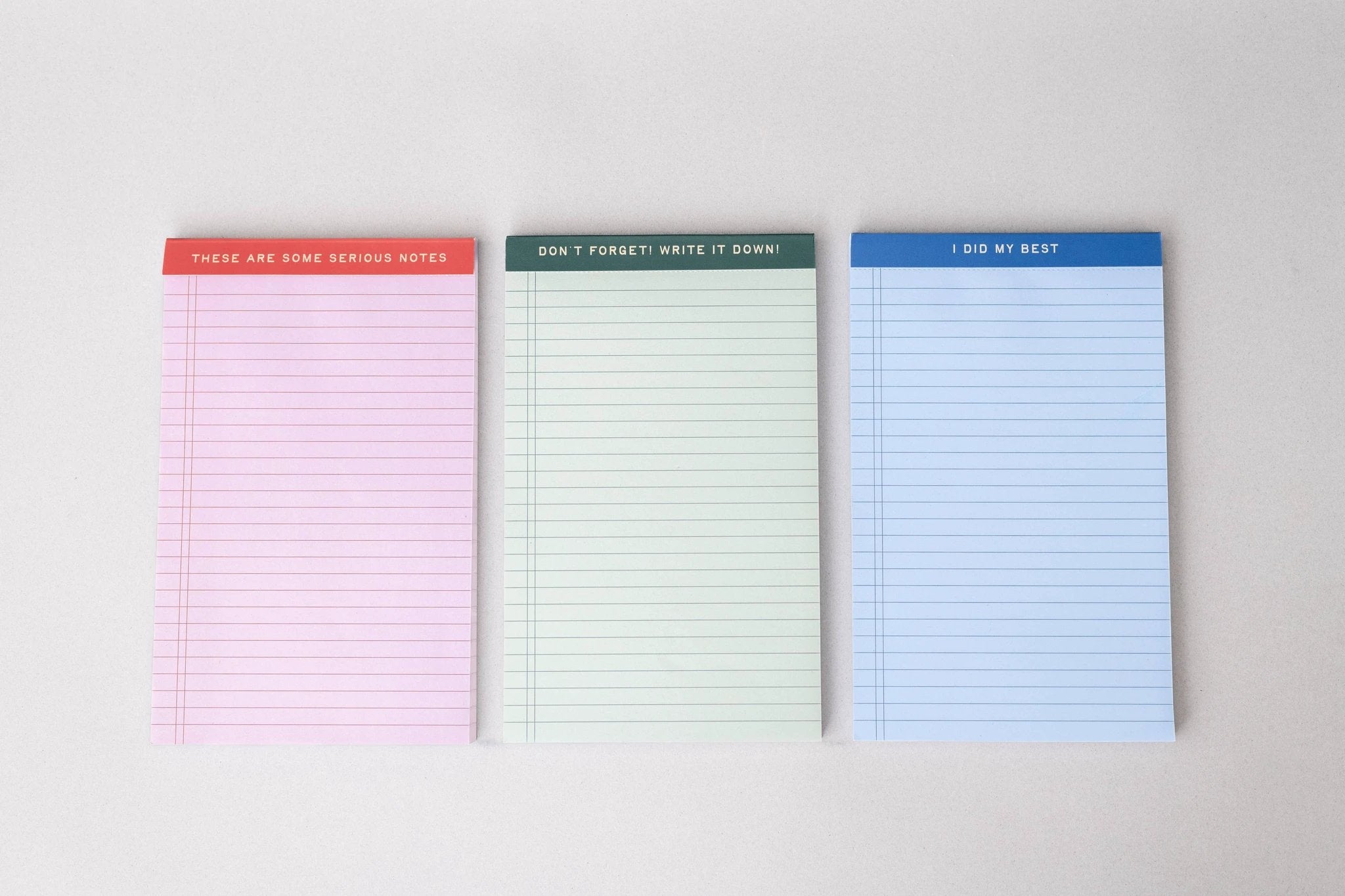 Mini Legal Pad Set: three colored pads (pink, cream, blue) with unique header phrases.
